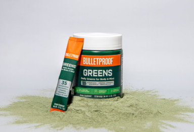 Bulletproof Greens container and to-go pack on top of powder.