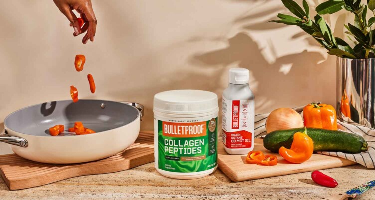 Bulletproof Collagen Peptides and Brain Octane Oil sitting next to kitchenware and vegetables