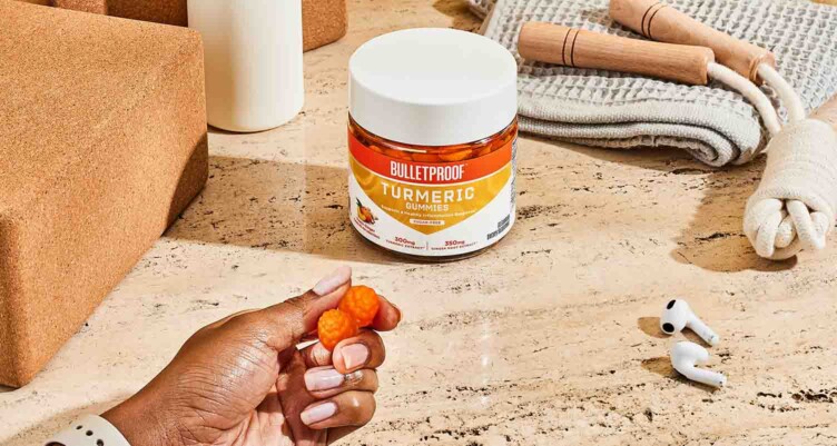 Hand holding two Bulletproof Turmeric Gummies