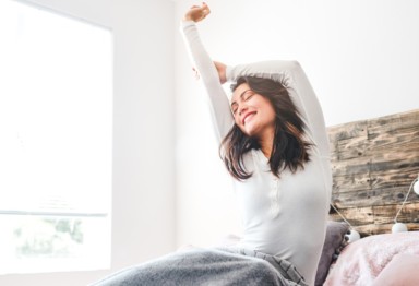 Woman waking up feeling well-rested.