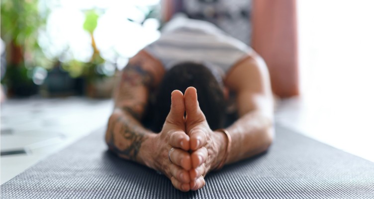 Man doing yoga pose to open shoulders.