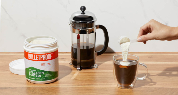 Adding scoop of Bulletproof Unflavored Collagen Protein to a cup of coffee