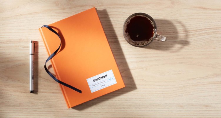 Bulletproof journal and cup of coffee on a desk