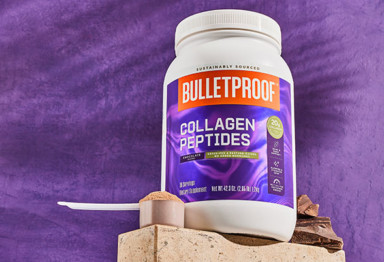 large container of chocolate collagen peptides against a purple background