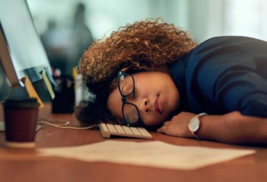 Woman sleeping at her desk