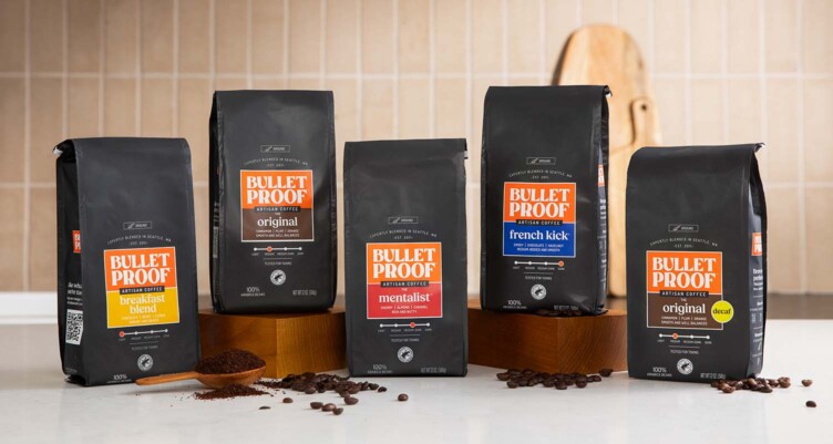 Bulletproof ground coffee roasts sitting on kitchen countertop