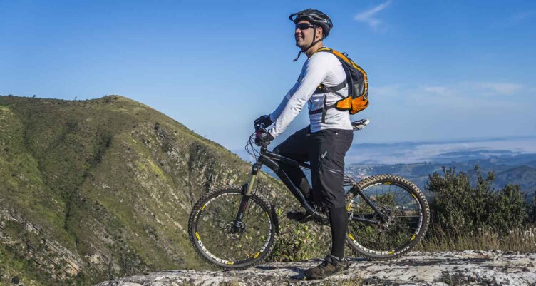 Man on bike looking at the mountaintop views