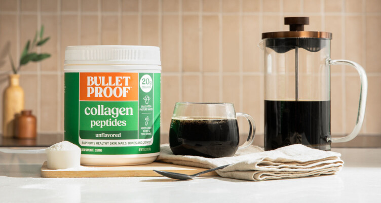 Bulletproof coffee next to Bulletproof Collagen Peptides in a kitchen setting.