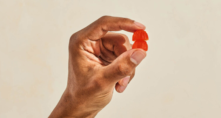 Hand holding two Bulletproof Energy Gummies