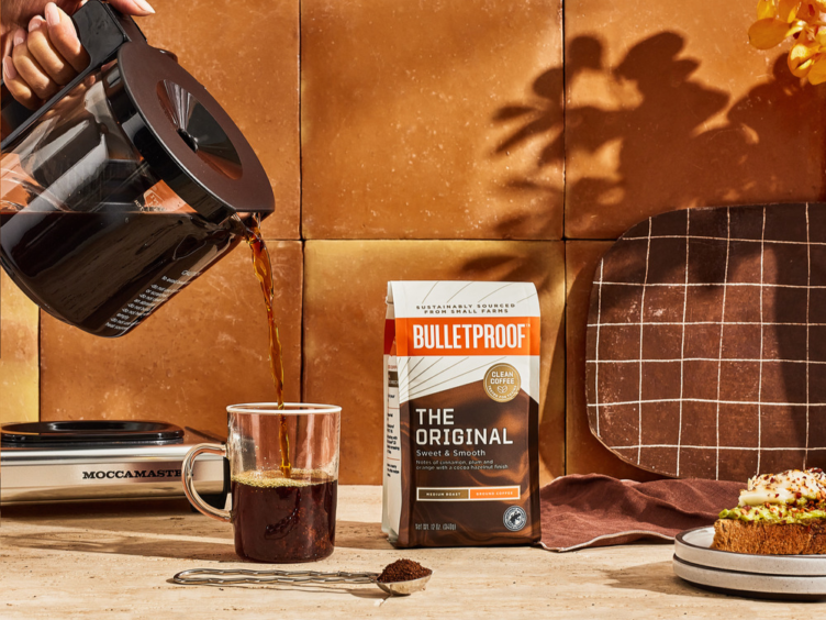Bulletproof Coffee being poured into a mug from a Moccamaster Coffee Maker