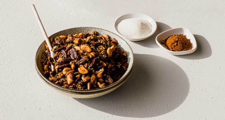 bowl of granola next to spices