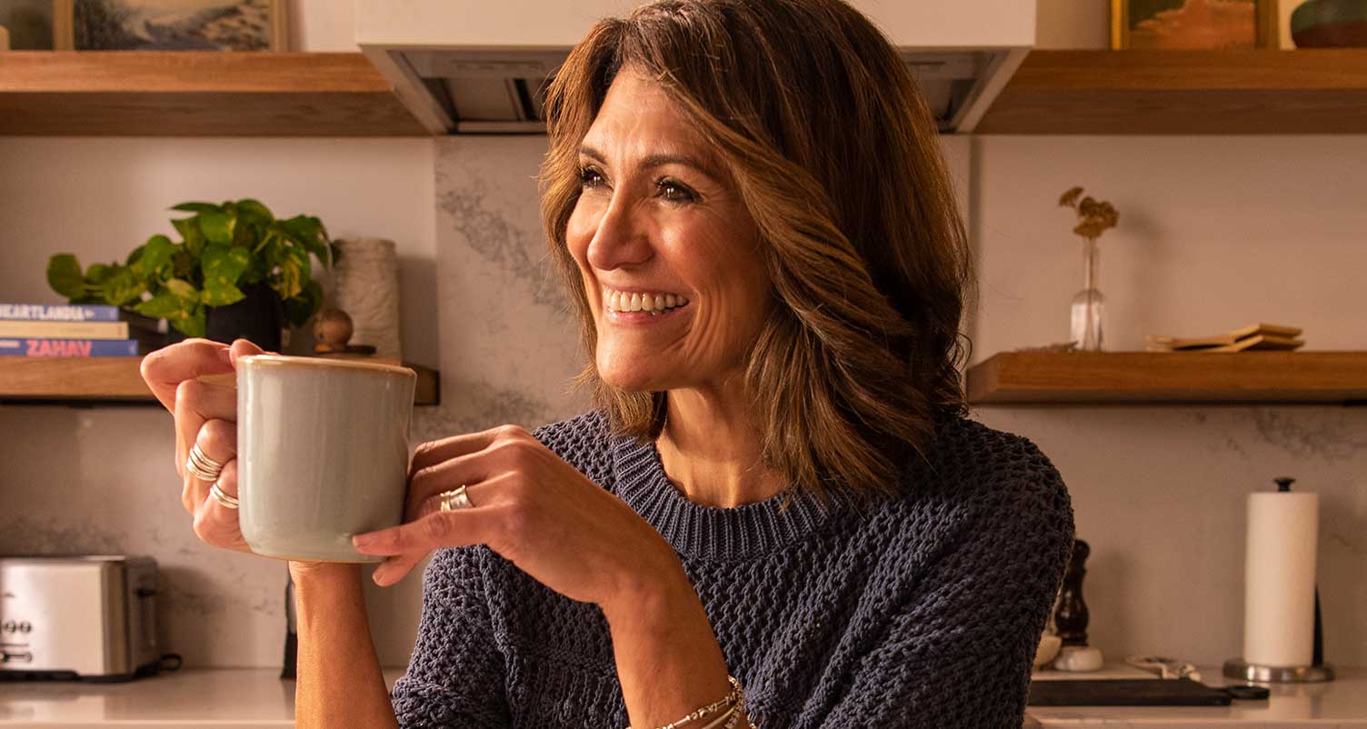 woman with healthy skin holding a cup of coffee