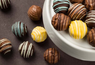 Assortment of keto fudge balls on a white ceramic serving dish