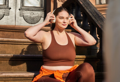 Woman putting on headphones getting ready for a run
