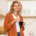 woman mixing her freshly made coffee in the kitchen