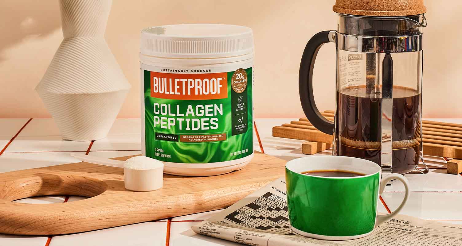 tub of collage peptides with a scoop of collagen next to it. a coffee press machine with coffee in it and a full cup of coffee