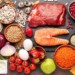 foods with a high satiety index on a counter. salmon, meat, vegetables, fruit, eggs