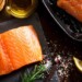 raw salmon on table with cooking ingredients