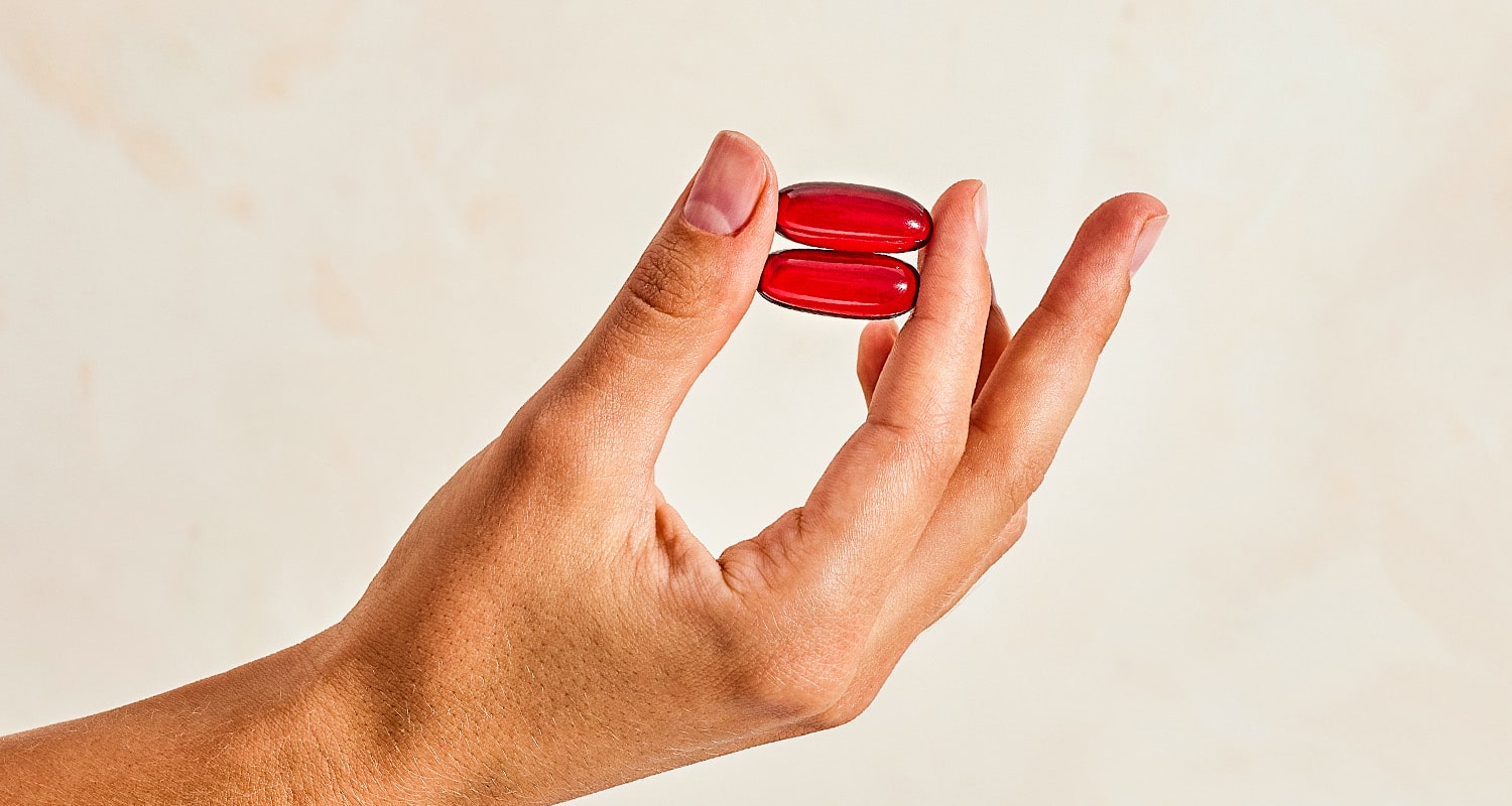 two fish oil pills in a hand