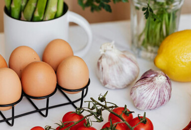 eggs, garlic, lemon, tomatoes on counter