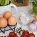 eggs, garlic, lemon, tomatoes on counter