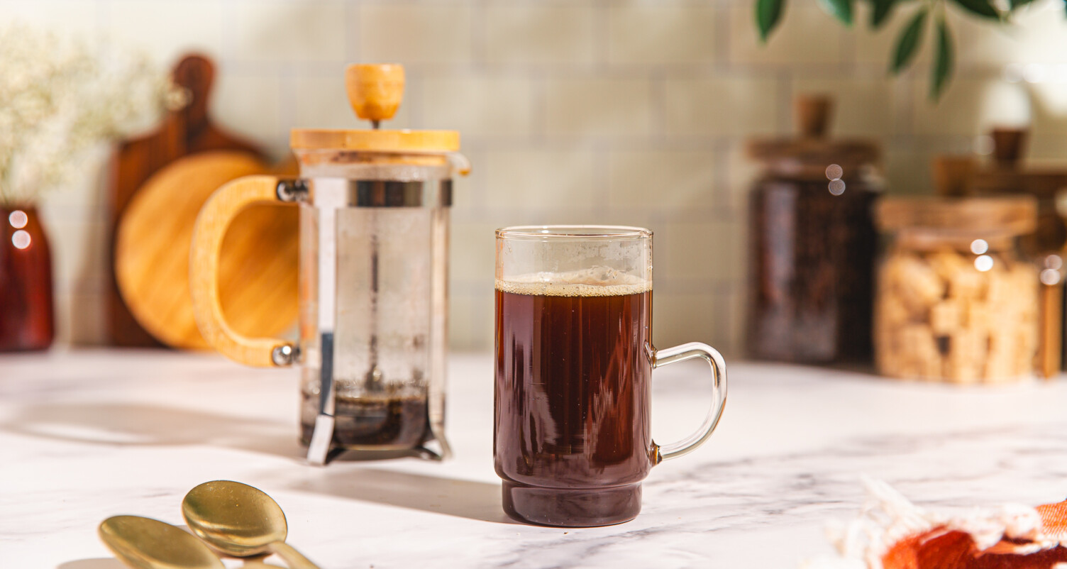coffee in a glass mug and a french press
