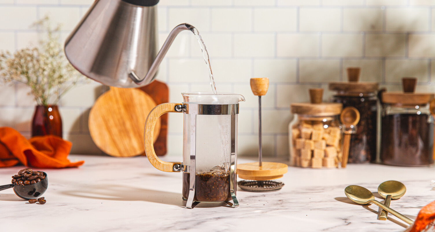 pouring water onto coffee in a french press