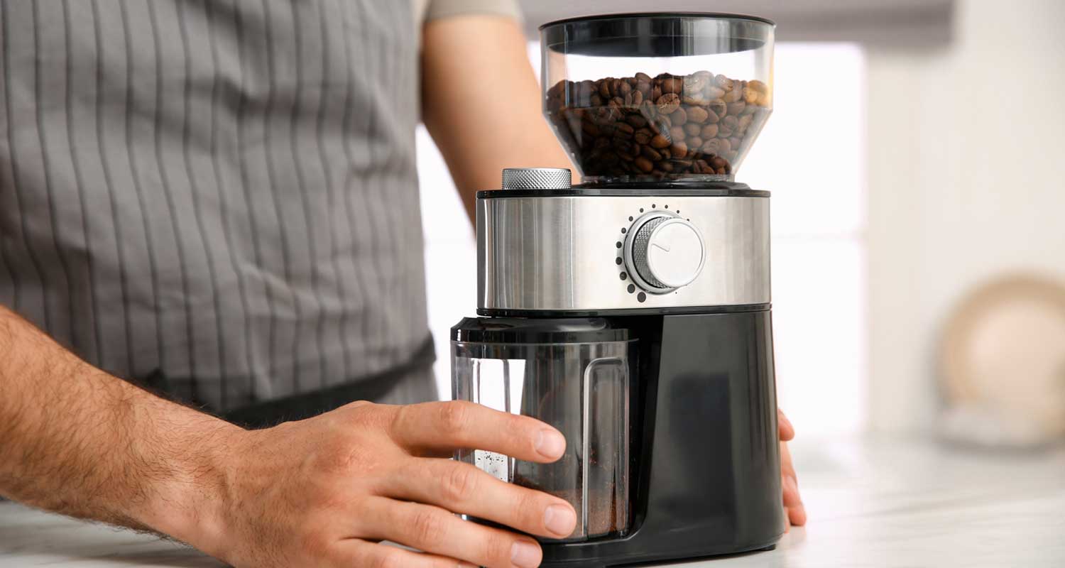 person grinding coffee