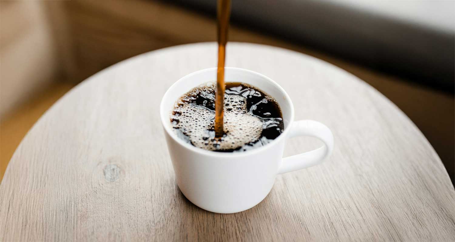 black coffee going into a white cup