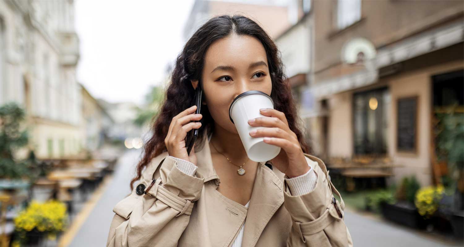 woman drinking coffee on the go