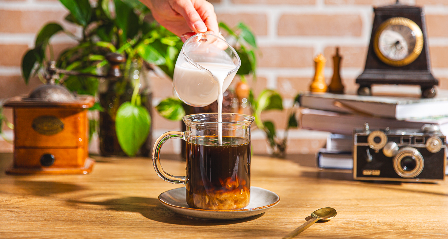 milk being poured into coffee