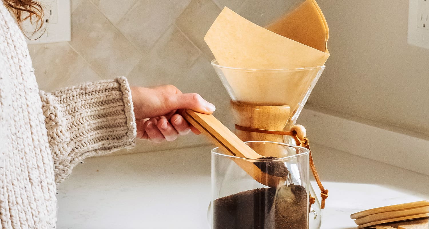 woman scooping coffee