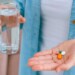 Hand holding water and supplements