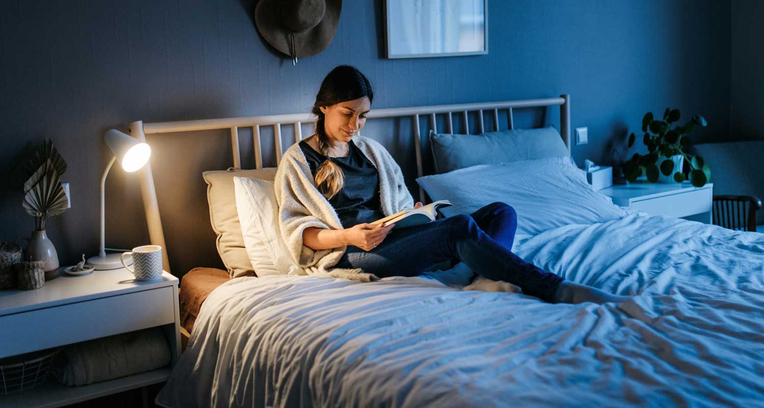 Woman reading in bed