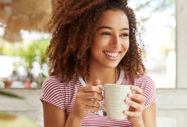 person drinking coffee feeling happy or stress free