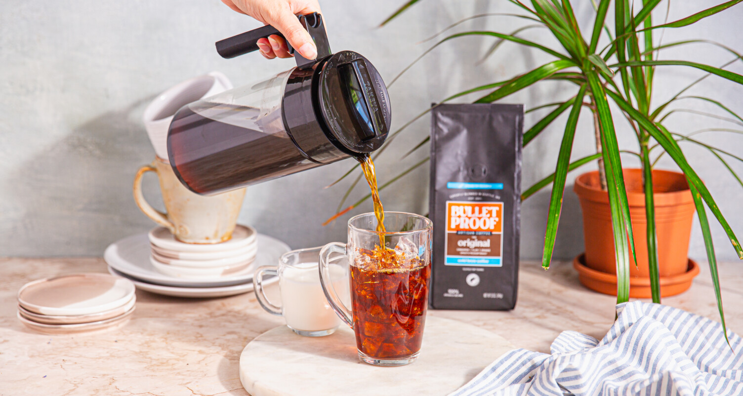 pouring cold brew into a glass
