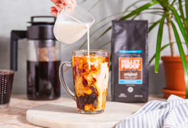 milk being poured into cold brew