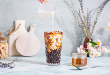 milk poured into a lavender cold brew latte