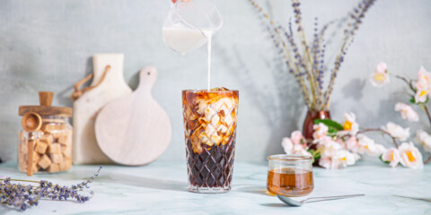 milk poured into a lavender cold brew latte