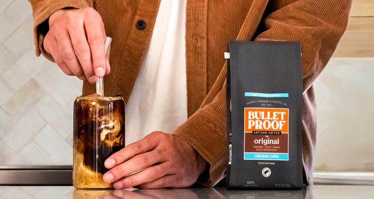 man stirring cold brew coffee with milk