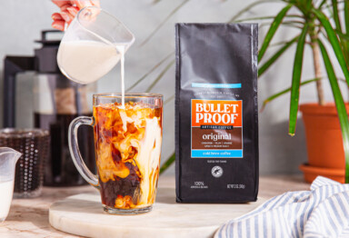 milk pouring into cold brew coffee