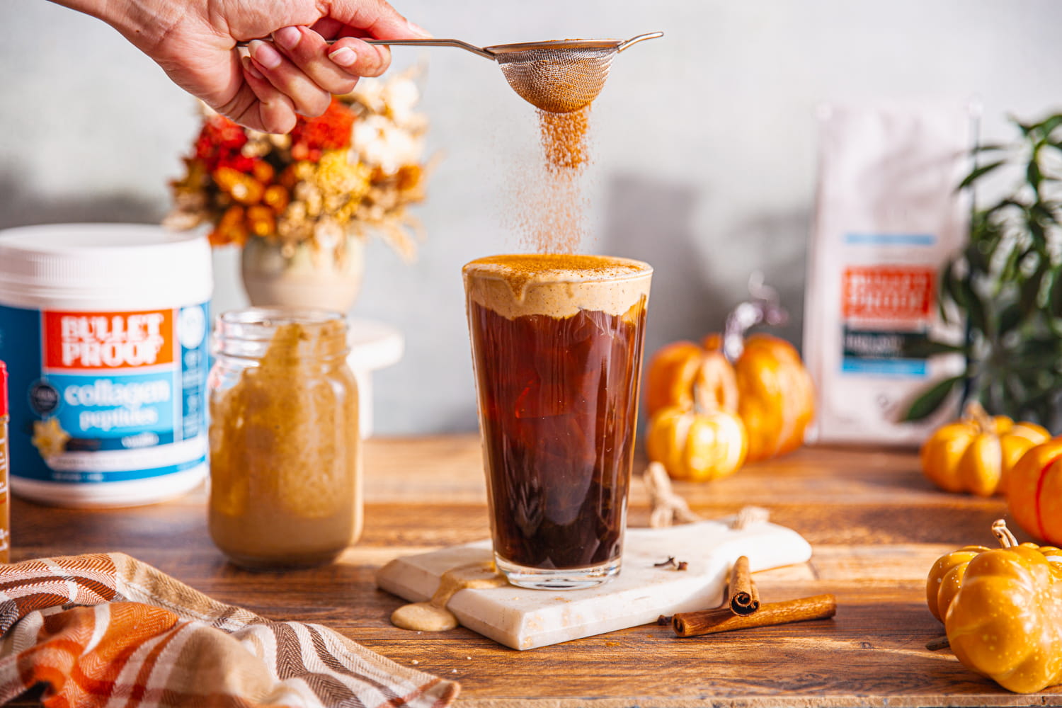 topping coffee drink with pumpkin pie spice