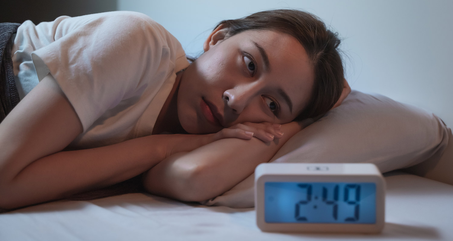 Image of someone sleeping or lying awake in bed