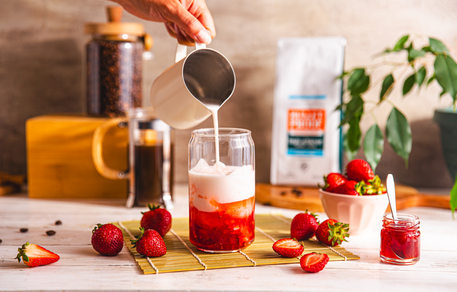 adding stawberry milk to cold brew