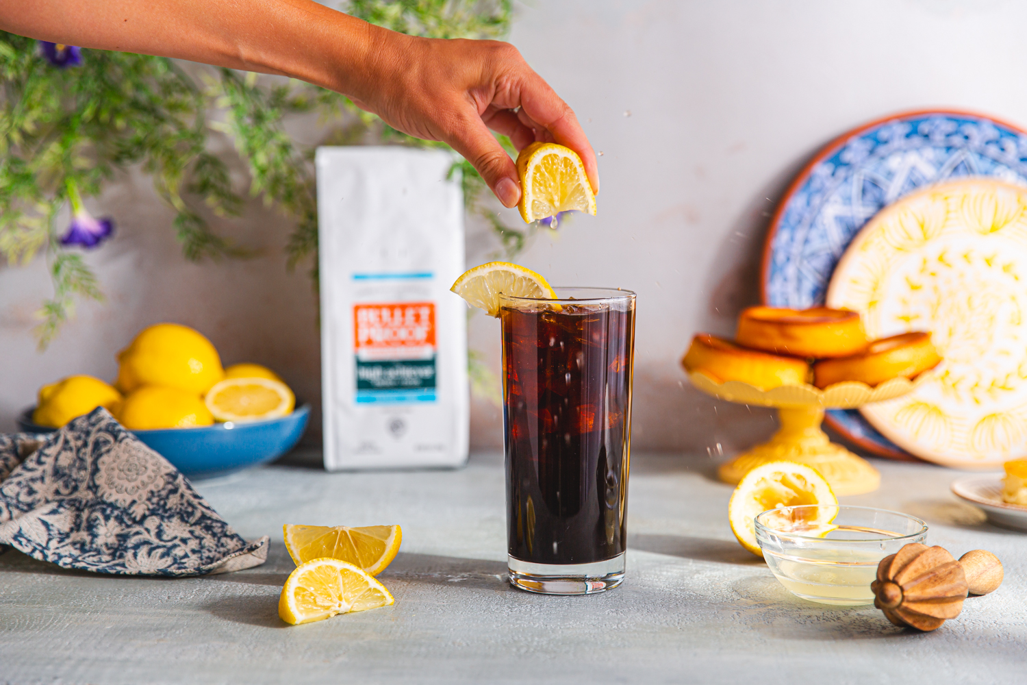squeezing lemon into cold brew