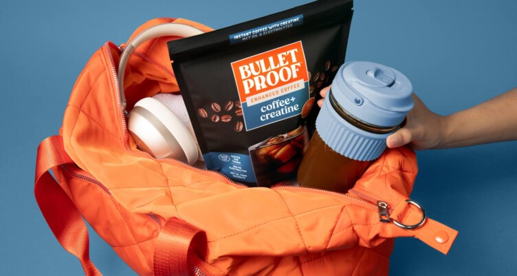 Gym bag packed with water bottle and Bulletproof coffee + creatine
