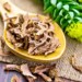 Dried Rhodiola rosea root, an adaptogenic herb used for energy and stress support, on a wooden spoon