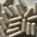 A pile of off-white memory supplement capsules scattered on a white surface.